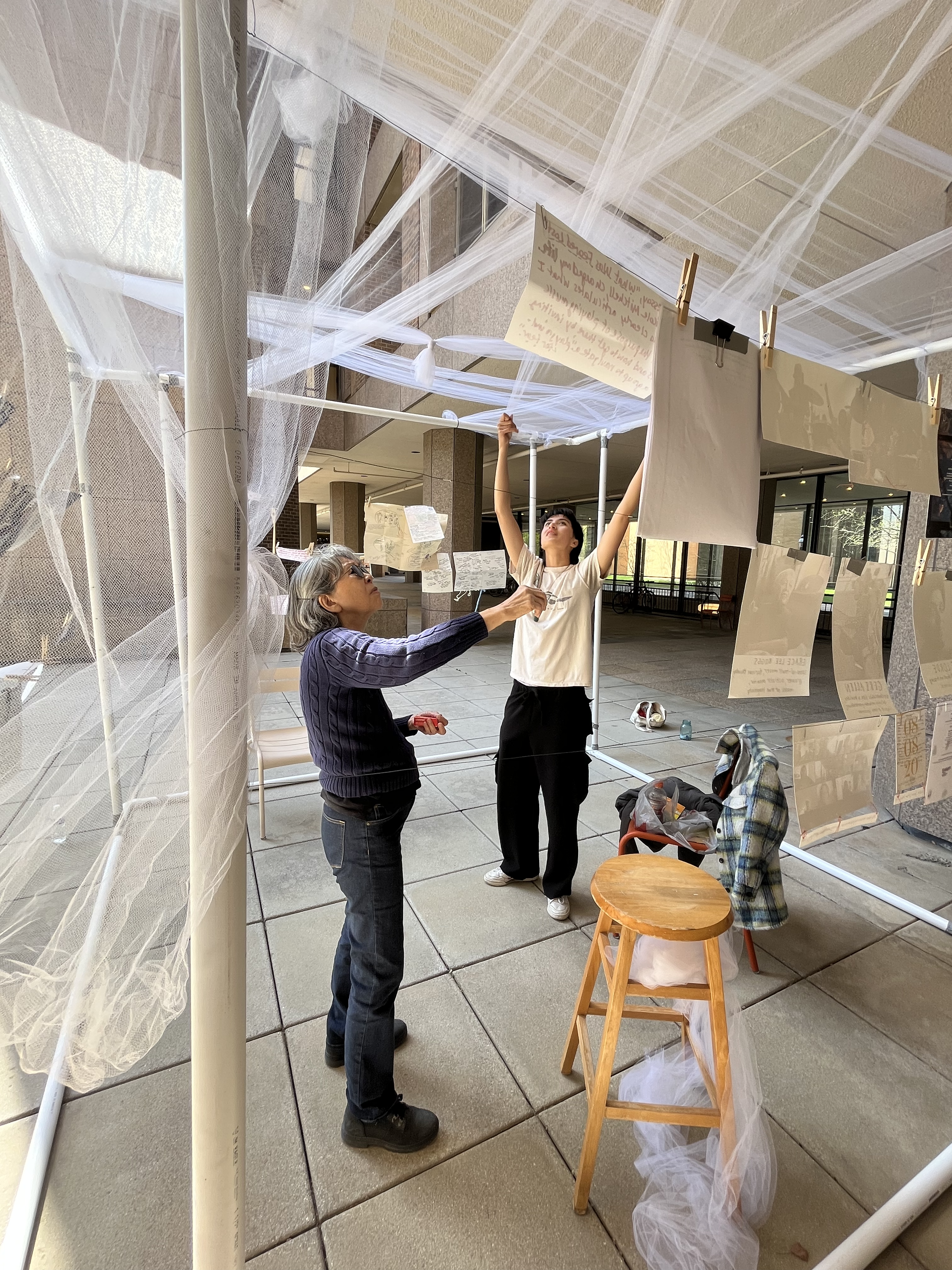 vertical shot of maya putting up the structure